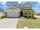 Charming two-story home featuring a two-car garage, brick accents, and freshly manicured front yard at 2759 Slash Way, St Cloud, FL 34771