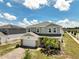 Beautiful two-story home featuring a two-car garage, brick accents, and freshly manicured front yard at 2759 Slash Way, St Cloud, FL 34771