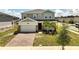 Charming two-story home featuring a two-car garage, brick accents, and freshly manicured front yard at 2759 Slash Way, St Cloud, FL 34771
