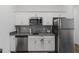 Updated kitchen features stainless appliances, subway tile backsplash, and white cabinets at 2759 Slash Way, St Cloud, FL 34771