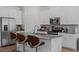Modern kitchen island with stainless steel appliances, gray countertops, and stylish bar seating, a chef's dream at 2759 Slash Way, St Cloud, FL 34771