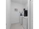 Efficient laundry room with modern washer and dryer, plus storage and ironing setup at 2759 Slash Way, St Cloud, FL 34771