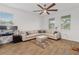 Bright living room featuring a sectional sofa, wood-look flooring and natural light at 2759 Slash Way, St Cloud, FL 34771