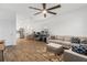 Open-concept living room and kitchen with wood-look flooring and lots of natural light at 2759 Slash Way, St Cloud, FL 34771