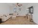 Comfortable living room with a sectional sofa, wood-look flooring, and a ceiling fan at 2759 Slash Way, St Cloud, FL 34771