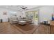 Cozy living room featuring a large sectional sofa, plush rug, and sliding glass doors that leads to outdoor patio at 2759 Slash Way, St Cloud, FL 34771