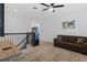 Upstairs loft area with carpet flooring, a comfortable couch, and an arcade game, great for Gathering fun and relaxation at 2759 Slash Way, St Cloud, FL 34771