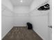 Clean walk-in closet featuring shelving for storage and a carpeted floor at 2759 Slash Way, St Cloud, FL 34771
