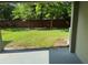A covered lanai offers a shady spot overlooking a backyard with mature trees and a brick privacy fence at 2940 Tanzanite Ter, Kissimmee, FL 34758