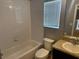 This bathroom features neutral walls, tile flooring, granite countertops, and window for natural light at 2940 Tanzanite Ter, Kissimmee, FL 34758