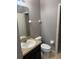 This bathroom features neutral walls, granite countertops, tile flooring, and white fixtures at 2940 Tanzanite Ter, Kissimmee, FL 34758
