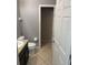 This bathroom features neutral walls, granite countertops, tile flooring, and white fixtures at 2940 Tanzanite Ter, Kissimmee, FL 34758