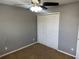 This bedroom features neutral walls, carpet flooring, ceiling fan, and a double door closet at 2940 Tanzanite Ter, Kissimmee, FL 34758