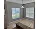Bright breakfast nook with large windows, pendant lighting, and beautiful tile flooring adjacent to the kitchen at 2940 Tanzanite Ter, Kissimmee, FL 34758