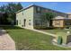 Two-story townhouse with well-kept lawn, neat shrubbery, and brick walkway to the front door at 2940 Tanzanite Ter, Kissimmee, FL 34758