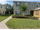 Well-maintained townhouse with green lawn, neat landscaping, and inviting walkway to covered entry at 2940 Tanzanite Ter, Kissimmee, FL 34758