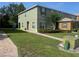Two-story townhouse with well-kept lawn, neat shrubbery, and brick walkway to the front door at 2940 Tanzanite Ter, Kissimmee, FL 34758