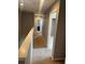 This hallway features neutral walls, carpet flooring, and two doors leading to the bathroom and bedroom at 2940 Tanzanite Ter, Kissimmee, FL 34758