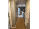 Upstairs hallway features brown carpet, neutral gray walls, and a closed door at the end at 2940 Tanzanite Ter, Kissimmee, FL 34758