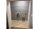 This laundry room features tile flooring, neutral paint, washer hookups, and shelving for added storage space at 2940 Tanzanite Ter, Kissimmee, FL 34758