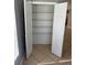 Linen closet with multiple wire shelves and a neutral wall color offering practical storage solutions at 2940 Tanzanite Ter, Kissimmee, FL 34758