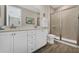 Lovely bathroom boasts a walk-in shower with glass door, a white vanity with a mirror and tile flooring at 2993 Caribbean Soul Dr, Kissimmee, FL 34747