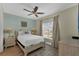 Bedroom features neutral walls, a ceiling fan and large windows for natural light with tile flooring at 2993 Caribbean Soul Dr, Kissimmee, FL 34747