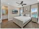 Spacious bedroom features neutral walls, ceiling fan and windows for natural light with a full ensuite bathroom at 2993 Caribbean Soul Dr, Kissimmee, FL 34747