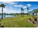 Scenic view of a lake surrounded by lush greenery and colorful townhomes in a vibrant community at 2993 Caribbean Soul Dr, Kissimmee, FL 34747