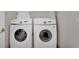 Well-equipped laundry area with a front loading washer and dryer for convenience at 2993 Caribbean Soul Dr, Kissimmee, FL 34747
