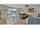 Inviting living room featuring a lake view, open to the kitchen and dining area for easy entertaining at 2993 Caribbean Soul Dr, Kissimmee, FL 34747