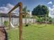 Tranquil backyard setup featuring a hammock, swing and a well maintained lawn at 301 Terranova Blvd, Winter Haven, FL 33884