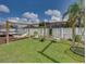 Serene backyard with a hammock and swing set with a privacy fence at 301 Terranova Blvd, Winter Haven, FL 33884