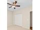 Spacious bedroom featuring a ceiling fan and a closet with white doors at 301 Terranova Blvd, Winter Haven, FL 33884