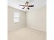 Cozy bedroom featuring a ceiling fan, window with blinds, and carpet floor at 301 Terranova Blvd, Winter Haven, FL 33884