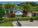 Beautiful Terranova community entrance with stone signage, lush landscaping, and bench seating at 301 Terranova Blvd, Winter Haven, FL 33884