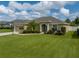 Charming single-story home with an arched entryway and meticulously manicured lawn at 301 Terranova Blvd, Winter Haven, FL 33884
