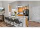Eat-in kitchen featuring counter seating, wood cabinets and stainless steel appliances at 301 Terranova Blvd, Winter Haven, FL 33884