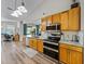 Well-equipped kitchen with stainless steel appliances and adjacent living space at 301 Terranova Blvd, Winter Haven, FL 33884