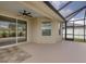 Covered patio with ceiling fan, tile flooring, and screened enclosure at 301 Terranova Blvd, Winter Haven, FL 33884