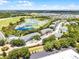Expansive aerial view showcases the community's serene lake, lush greenery, and convenient parking at 3111 Sun Lake Ct # B, Kissimmee, FL 34747