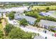An aerial view of a community featuring a pool and a pond in a lush landscaped environment at 3111 Sun Lake Ct # B, Kissimmee, FL 34747