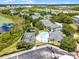 An aerial view of the community with a pool, tennis court, lush green landscaping, and surrounding neighborhood amenities at 3111 Sun Lake Ct # B, Kissimmee, FL 34747