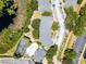 Aerial perspective featuring building roofs, parking, pool, tennis court, and green landscaping, emphasizing the community's amenities at 3111 Sun Lake Ct # B, Kissimmee, FL 34747