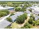 A high angle view shows the community with mature trees, swimming pool and plenty of parking at 3111 Sun Lake Ct # B, Kissimmee, FL 34747