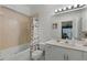 Bright bathroom featuring a shower-tub combo, single sink vanity, and neutral tiling at 3111 Sun Lake Ct # B, Kissimmee, FL 34747