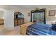 Bedroom with balcony access, dresser with TV, and comfortable king-sized bed at 3111 Sun Lake Ct # B, Kissimmee, FL 34747