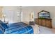 Relaxing bedroom featuring a comfortable king bed and an attractive dresser with a TV at 3111 Sun Lake Ct # B, Kissimmee, FL 34747