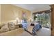 Comfortable bedroom with balcony access, cozy seating, and calming decor at 3111 Sun Lake Ct # B, Kissimmee, FL 34747