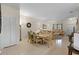 Open dining area adjacent to living space, featuring a wooden dining set and tile flooring at 3111 Sun Lake Ct # B, Kissimmee, FL 34747